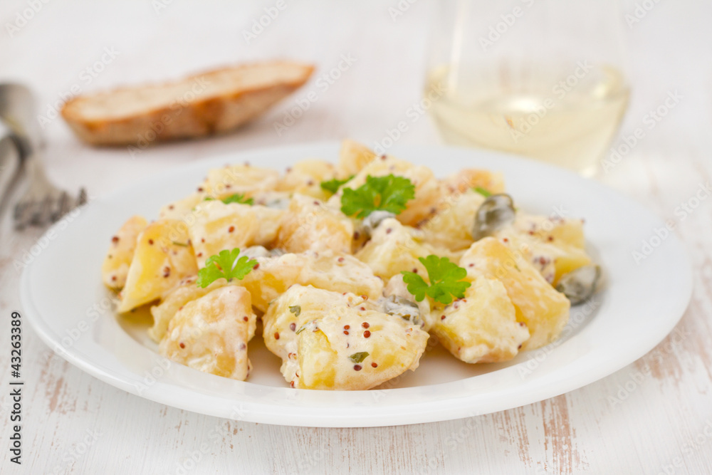 potato salad with sauce on the white plate