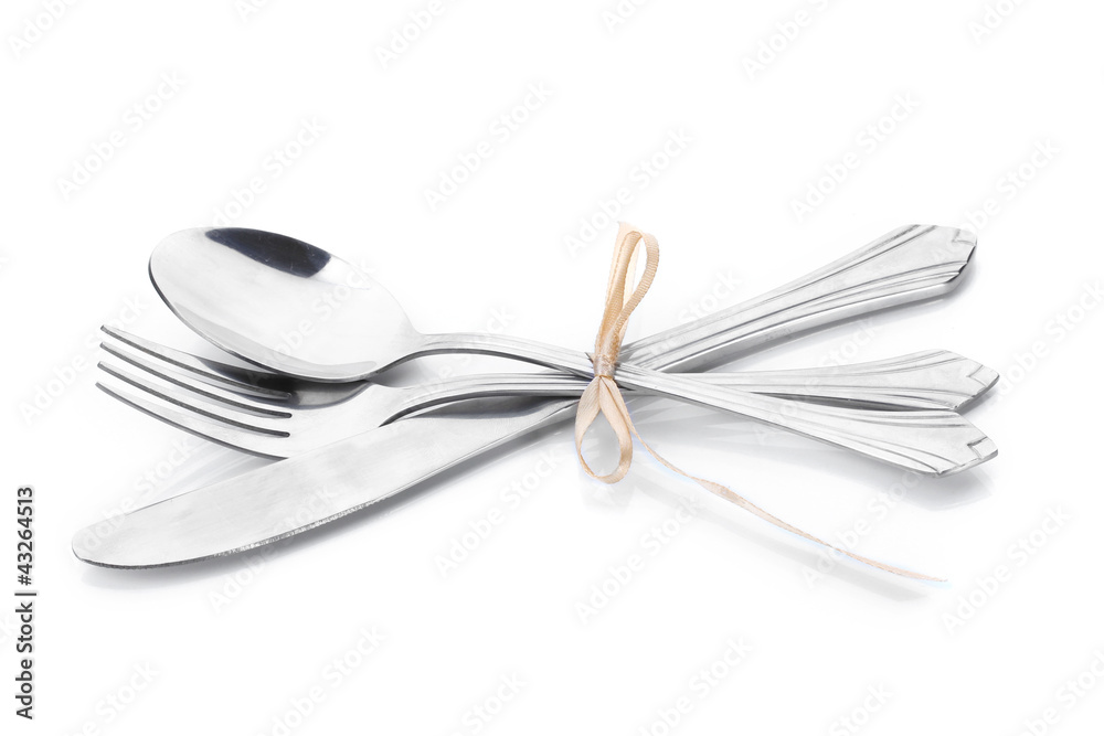 Silver fork, spoon and knife tied with ribbon isolated on white Silver fork, spoon and knife tied with ribbon isolated on white