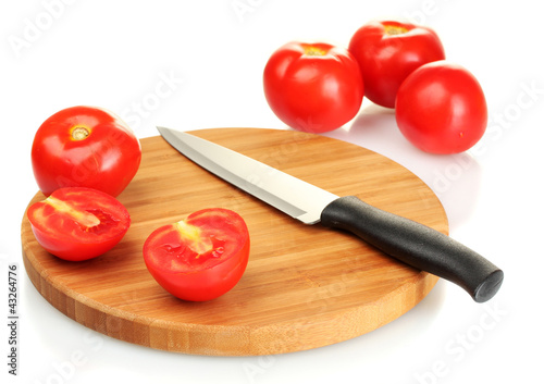 Ripe red tomatoes and knife on cutting board isolated on white