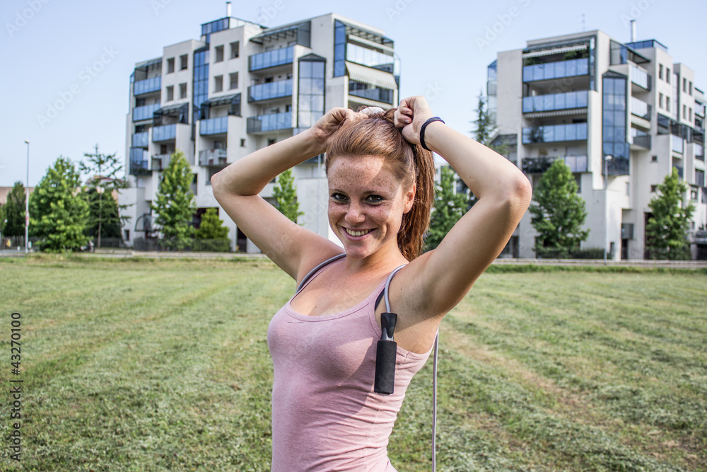 Sensual and smiling girl keep fit in a urban landscape