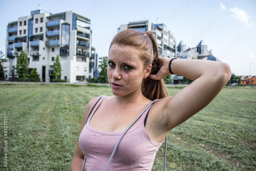 Sensual and tired girl keep fit in a urban landscape