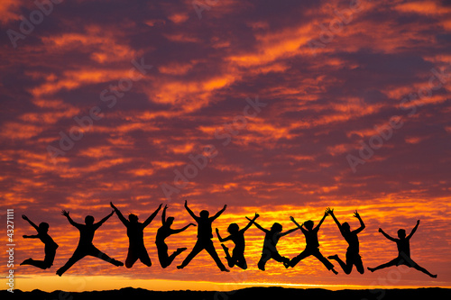 silhouette of teenagers jumping in sunset for fun © Alex Koch