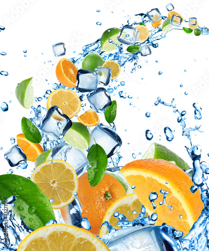 Fresh citruses in water splash with ice cubes