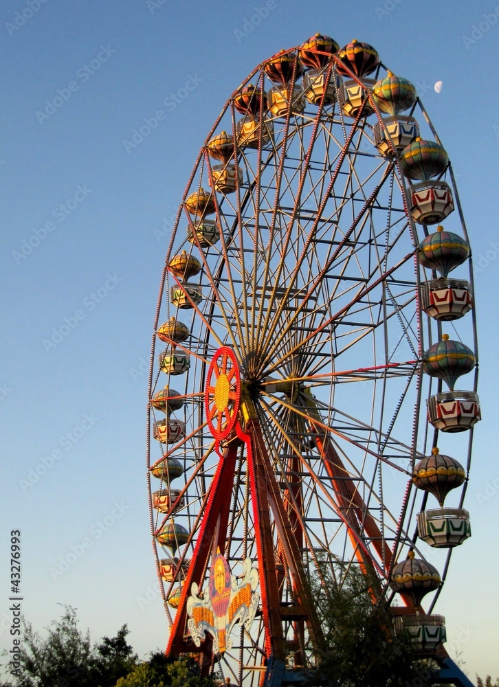 Colourful big ferris wheel in the blue sky