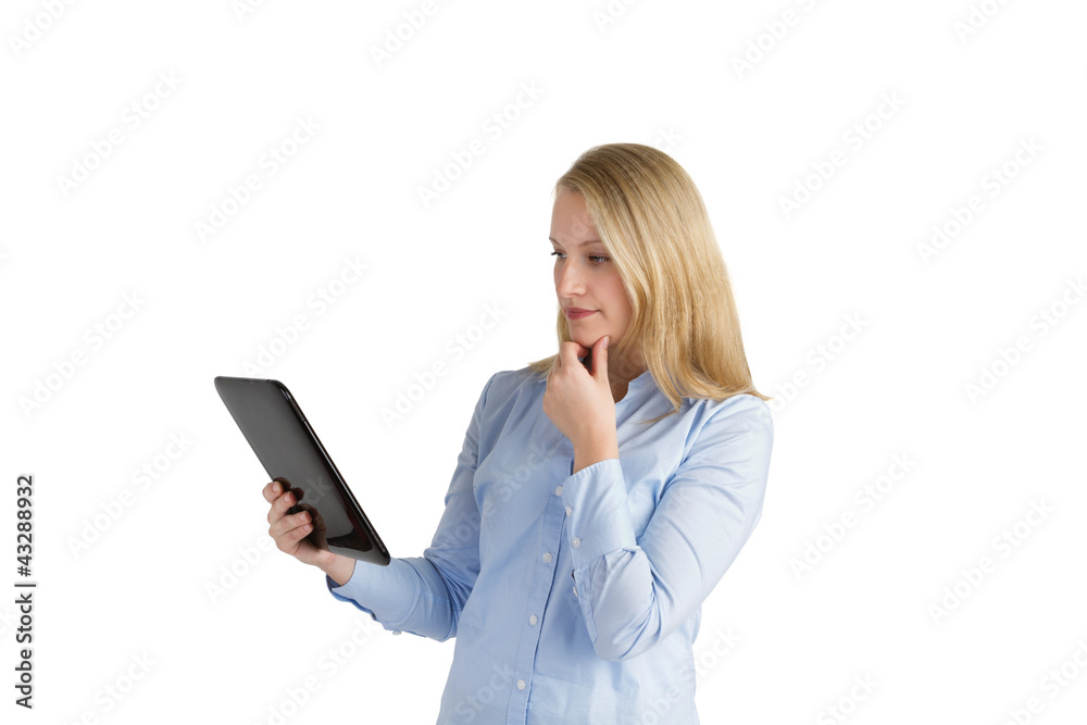 Attractive woman considering a handheld touch pad device Attractive woman considering a handheld touch pad device