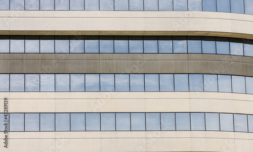 Blue Sky Reflected in Windows of Concrete and Glass Building