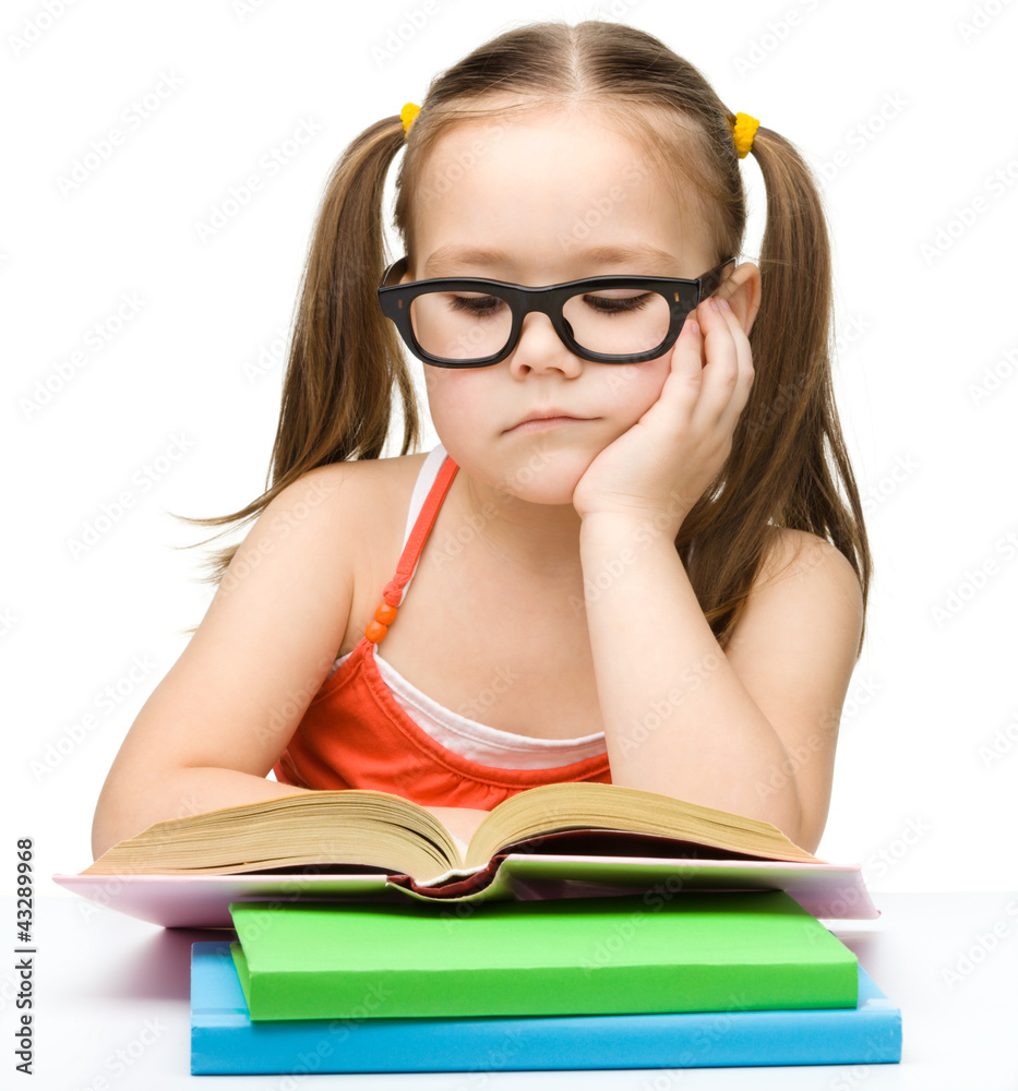 Cute little girl is reading book Cute little girl is reading book