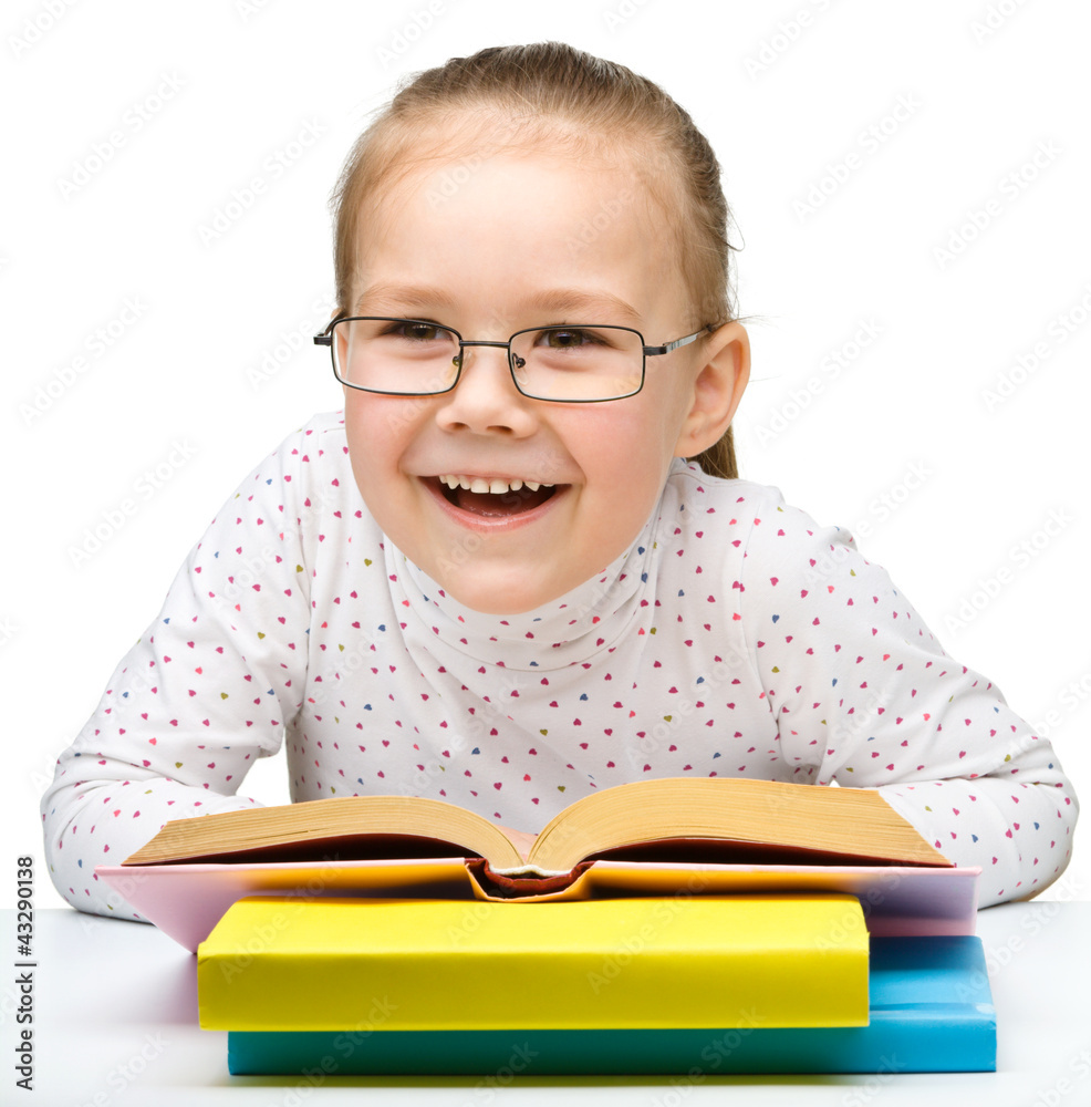 Cute cheerful little girl reading book Cute cheerful little girl reading book