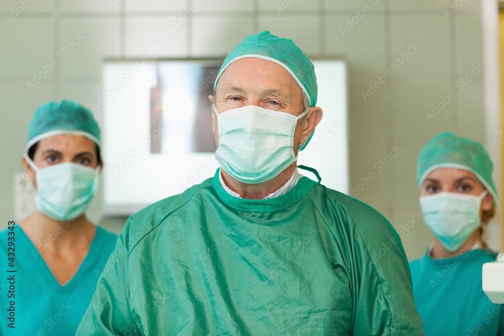 Surgeon with two interns behind him Surgeon with two interns behind him