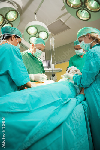 Medical team operating a patient