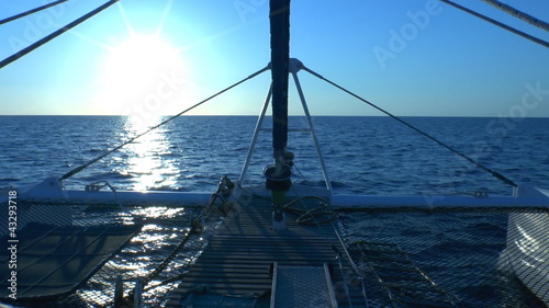 Catamaran, sailing to sunrise, Cuba