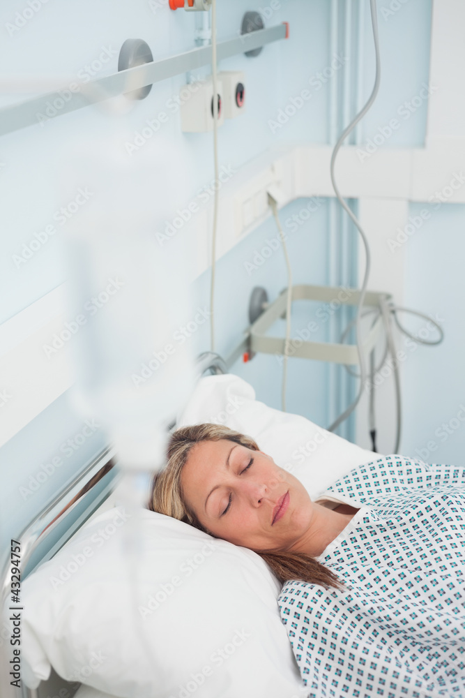 Woman lying on a medical bed while closing her eyes Woman lying on a medical bed while closing her eyes