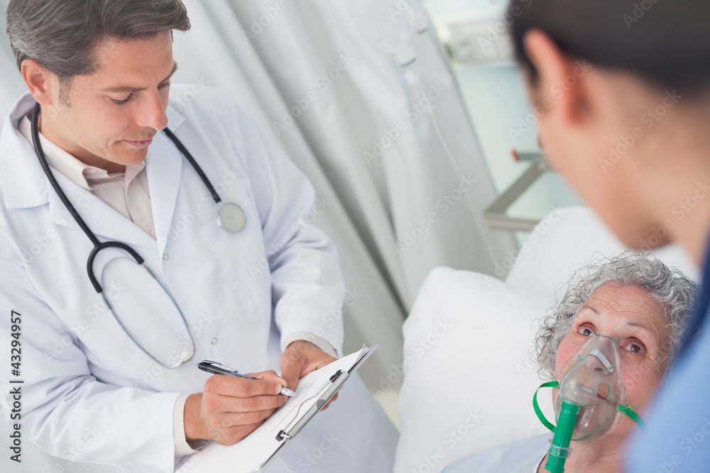Doctor writing on a clipboard with a pen Doctor writing on a clipboard with a pen