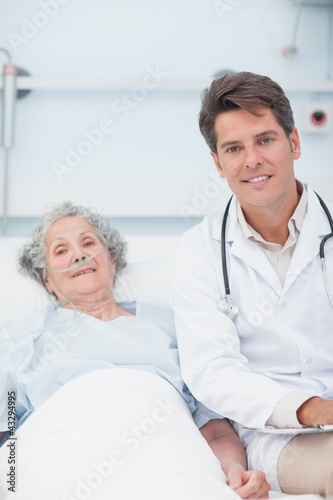 Doctor and patient on the bed looking at camera