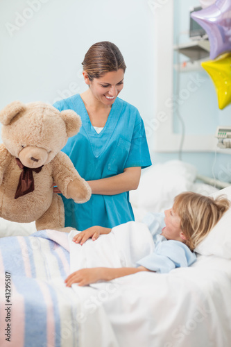 Nurse holding a teddy bear
