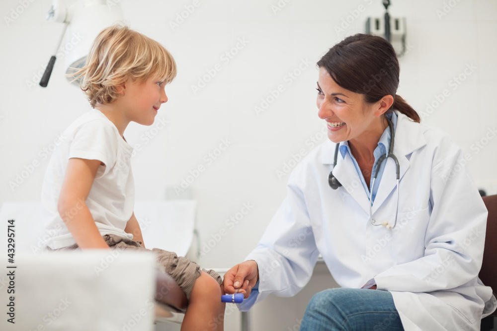Female doctor auscultating a child Female doctor auscultating a child