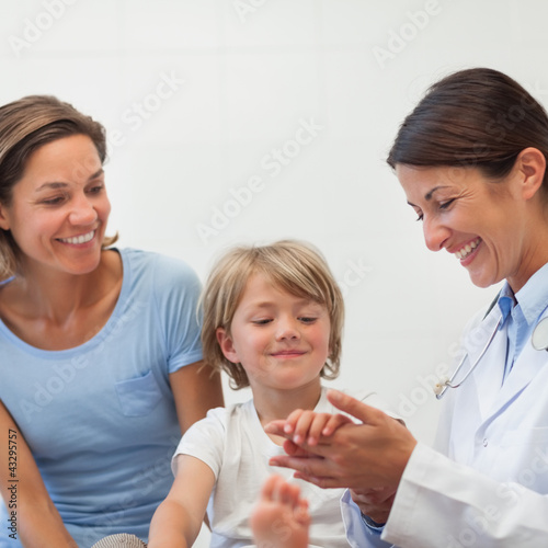 Doctor auscultating the forearm of a child