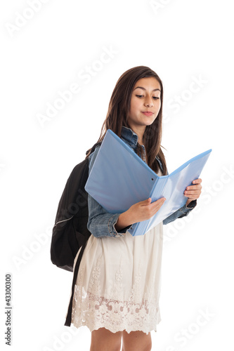 Fotografie Preteen schoolgirl looking at folder