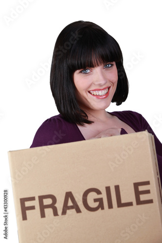 Woman with a box marked fragile © auremar