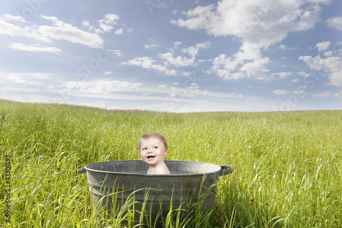 baby in an old vintage bathrub, outdoors photo