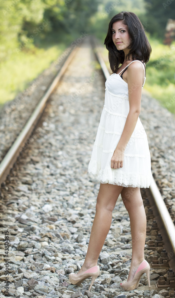 Cute young girl on a railroad