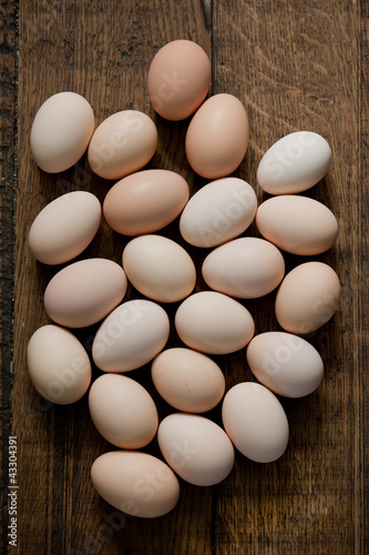 Brown eggs at wooden table background. Shallow depth of field