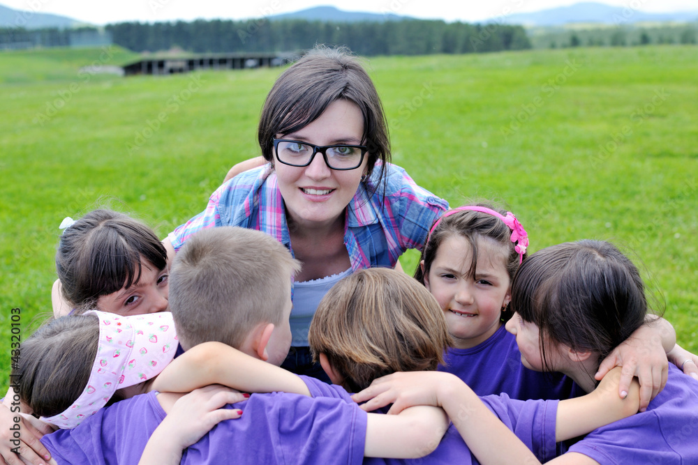 happy kids group with teacher in nature