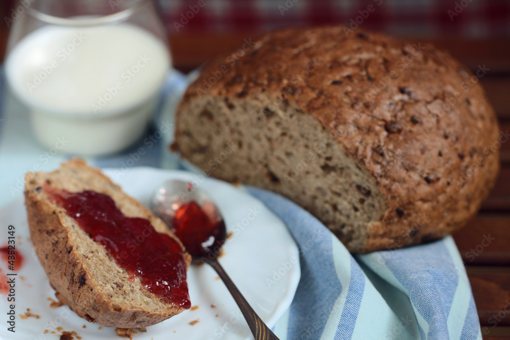breakfast - bread with strawberry jam and glass of milk