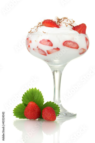 glass of ripe strawberries with cream isolated on white photo