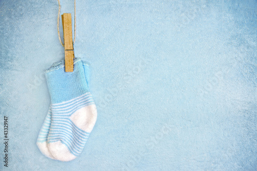 Blue baby socks on a textured background