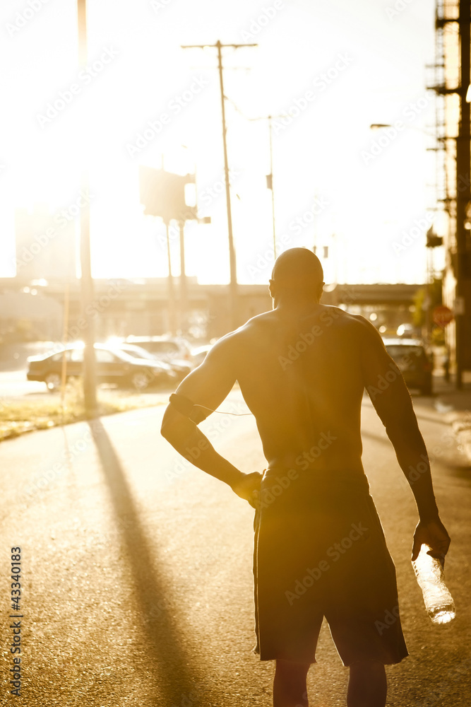 African American man drinking water after exercise African American man drinking water after exercise
