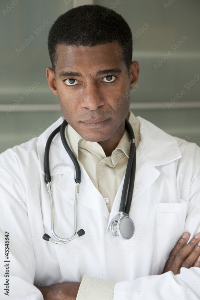 Black doctor in lab coat with arms crossed Black doctor in lab coat with arms crossed