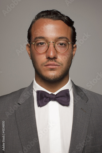 Serious Caucasian man in suit and bow tie