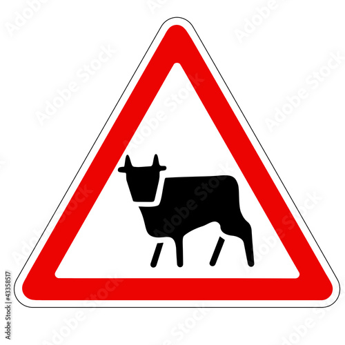 triangular traffic sign with a picture of a cow