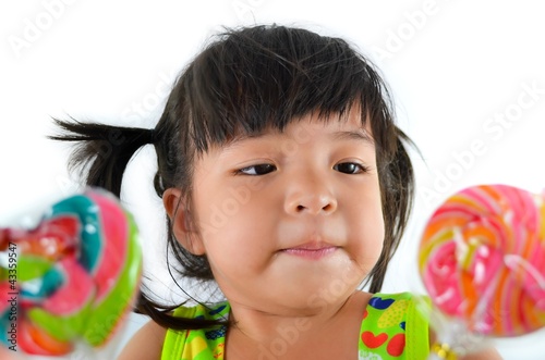 cute asian baby girl and big lollipop of thailand southeast asia