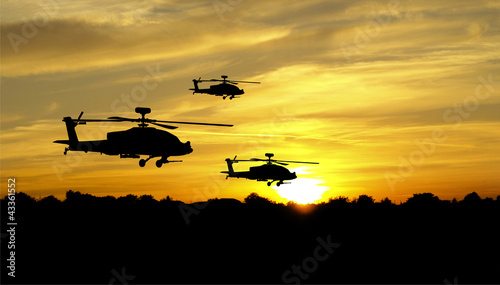 Helicopter silhouettes on sunset background © vadimmmus