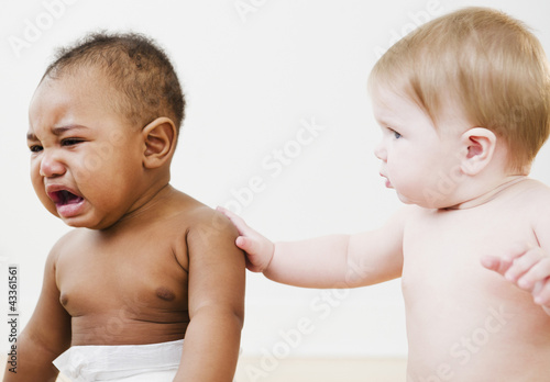 Baby consoling crying friend