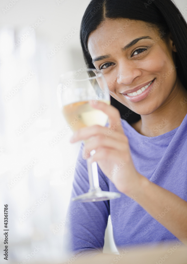 African American woman drinking white wine African American woman drinking white wine