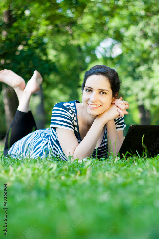 Beautiful young woman using her laptop outdoors Beautiful young woman using her laptop outdoors