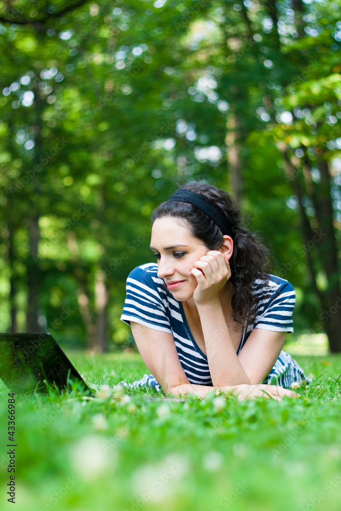 Beautiful young woman using her laptop outdoors Beautiful young woman using her laptop outdoors