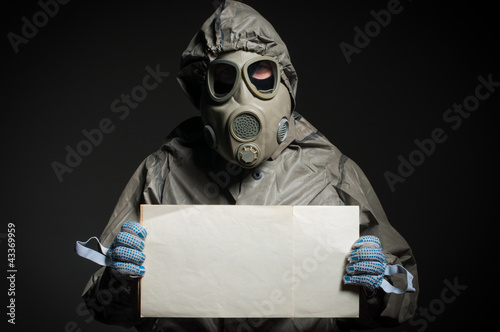Men in protective cloth and gas mask hold empty table