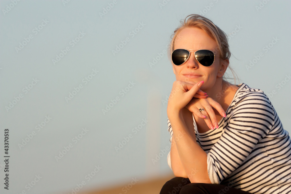 Beautiful girl is looking at the sunset Beautiful girl is looking at the sunset