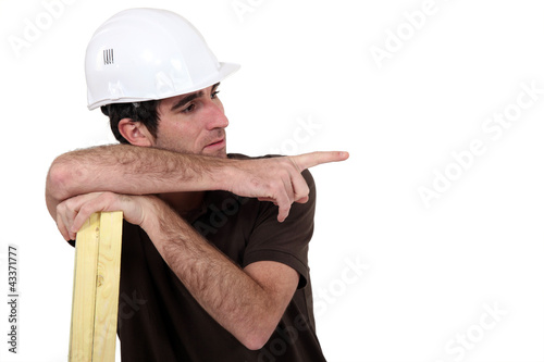 laborer leaning on planks
