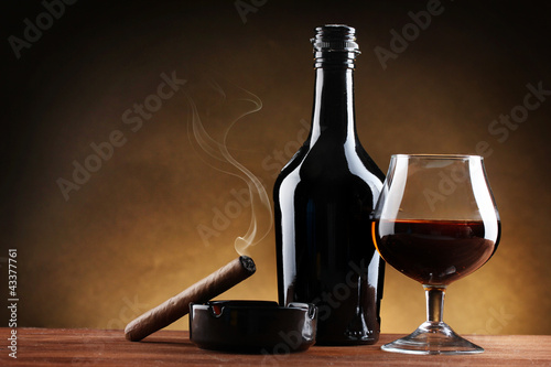 bottle and glass of brandy and cigar