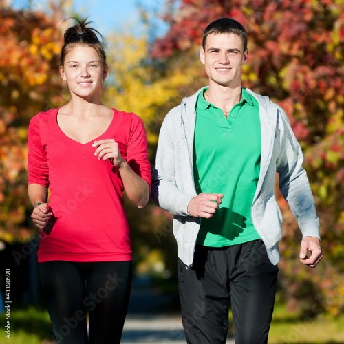 Young man and woman running
