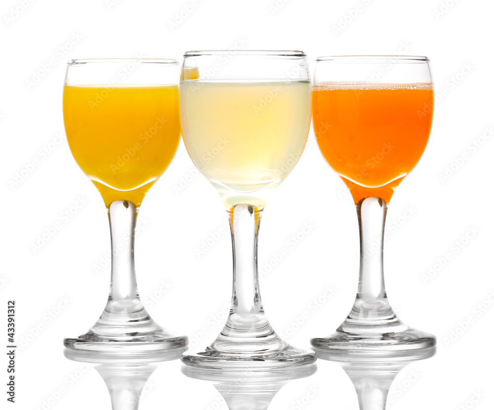 Tropical juices in glasses isolated on white Tropical juices in glasses isolated on white