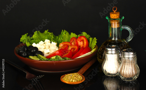 tasty greek salad isolated on black
