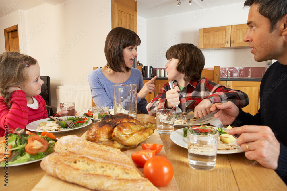Family Having Argument Whilst Eating Lunch Together In Kitchen Family Having Argument Whilst Eating Lunch Together In Kitchen