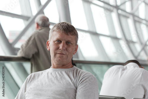 Free Download mature man in a waiting room of the international airport - GFXLoad
