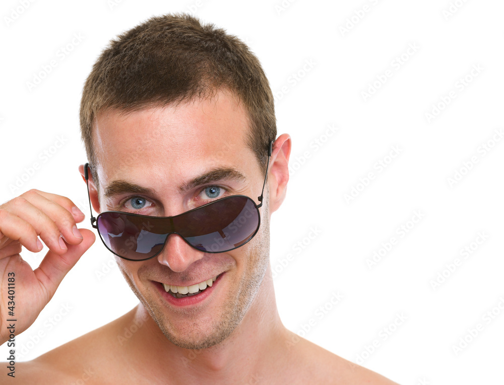 Portrait of smiling young man looking out from sunglasses